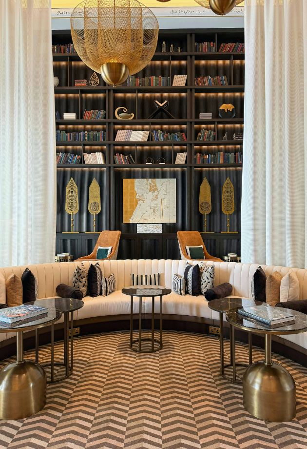 modern living room with a round couch and wooden chevron floor